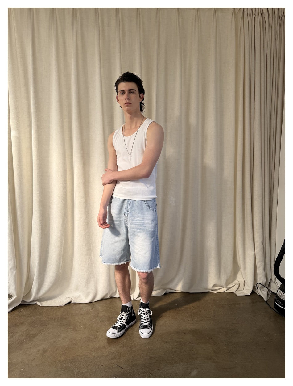 Model in a white tank top and light-wash denim shorts, shown at a slight angle.