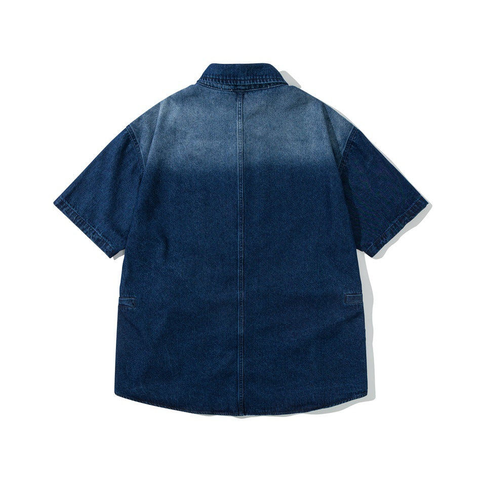 Back view of blue faded denim short-sleeve shirt with center back seam and a gradient wash