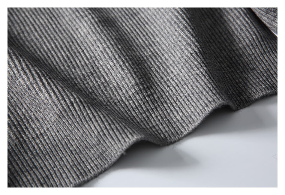 Close-up showing the gray cardigan's vertical rib-knit texture and hem edge.