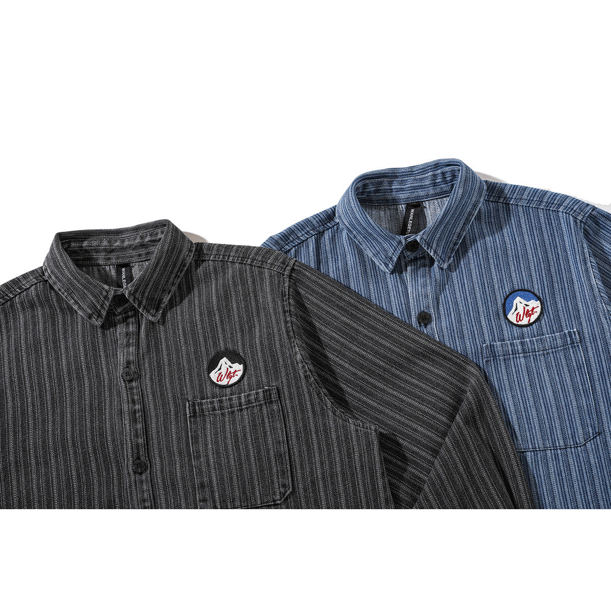 Close view of charcoal and blue pinstriped button-up shirts with chest pockets and embroidered mountain patches.