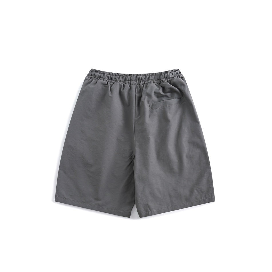 Back view of gray shorts with elastic waistband and a single welt pocket on the right back