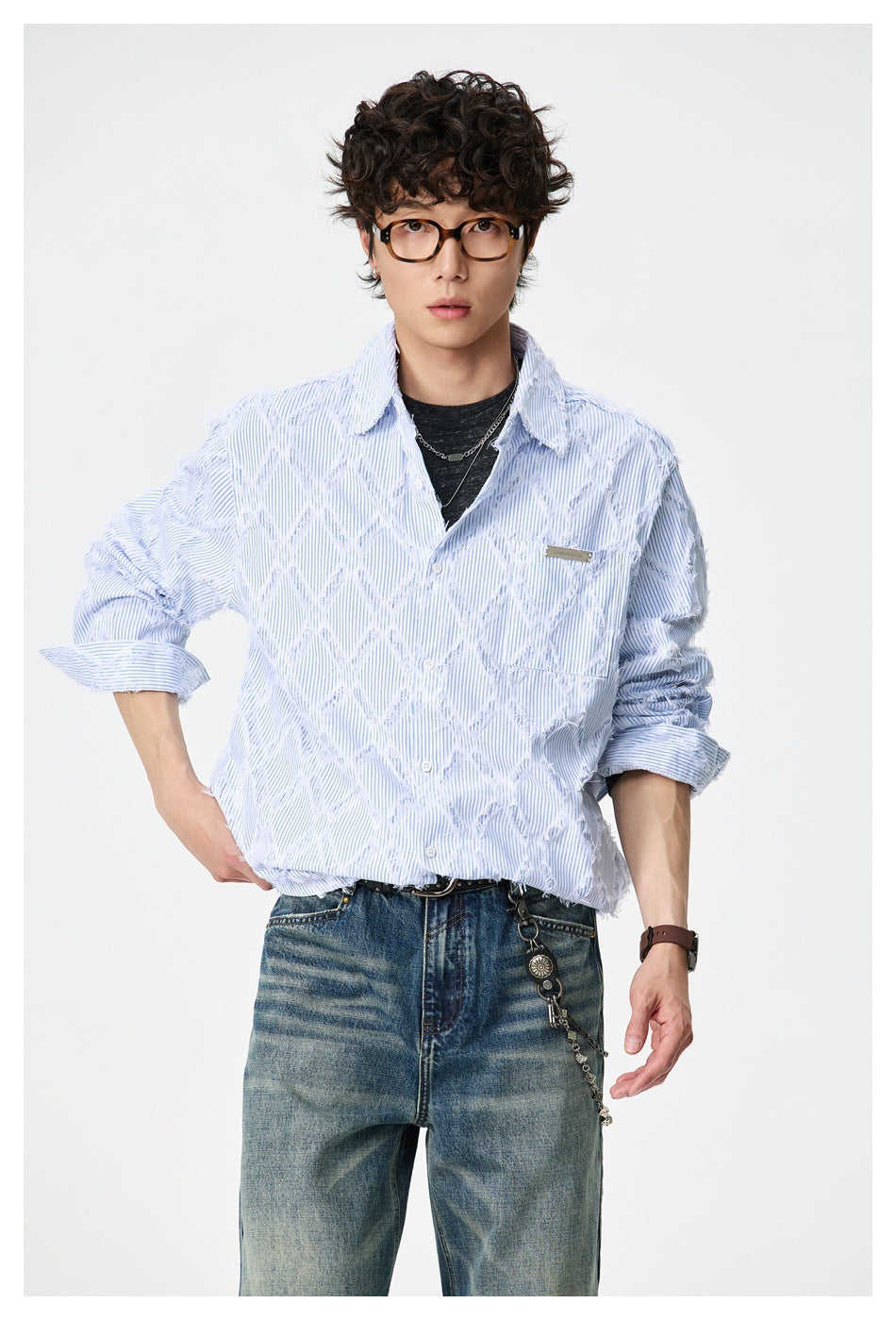 Front view of a model wearing a pale blue pinstriped button-up shirt with raised white diamond detailing.