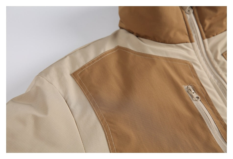 Close-up of a tan patch pocket with a short zipper on the cream-and-tan jacket.