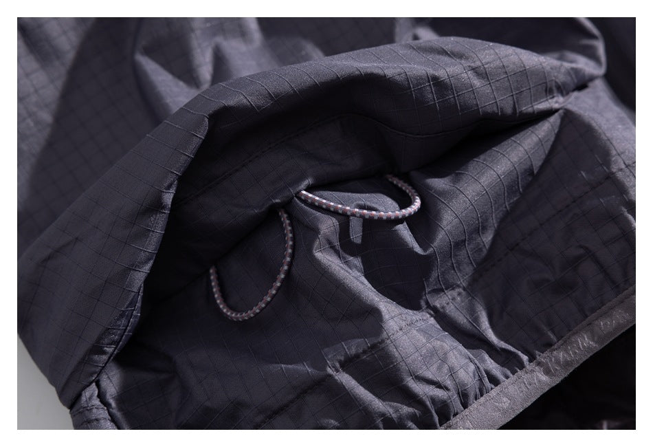 Close-up of a charcoal grid-patterned jacket interior with a looped drawcord.