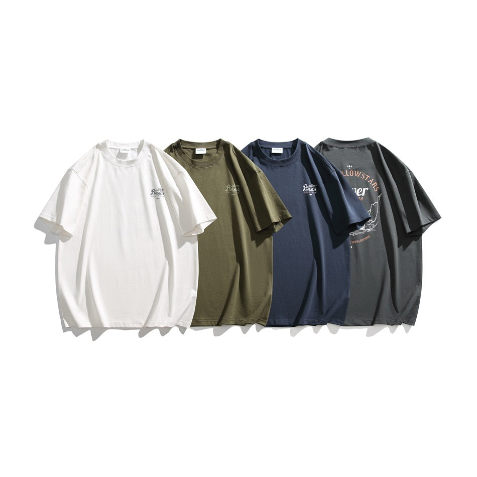 Four T-shirts arranged together in white, olive, navy, and charcoal, showing small chest graphics and a large back print.