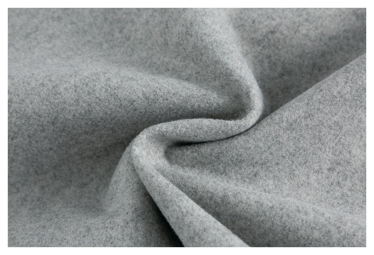Extreme close-up of the jacket's heather gray fabric folded to show its surface texture.