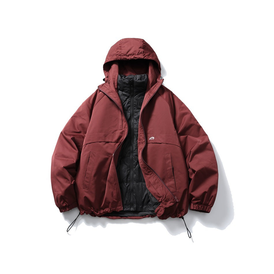 Front view of a burgundy hooded jacket worn open over a black quilted inner layer, laid flat on white.