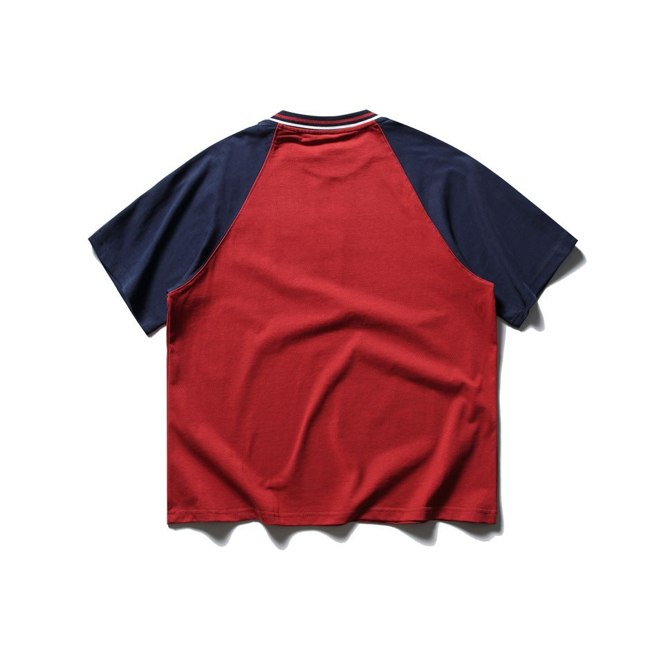 Back view of a red raglan T-shirt with navy sleeves and a striped ribbed collar.