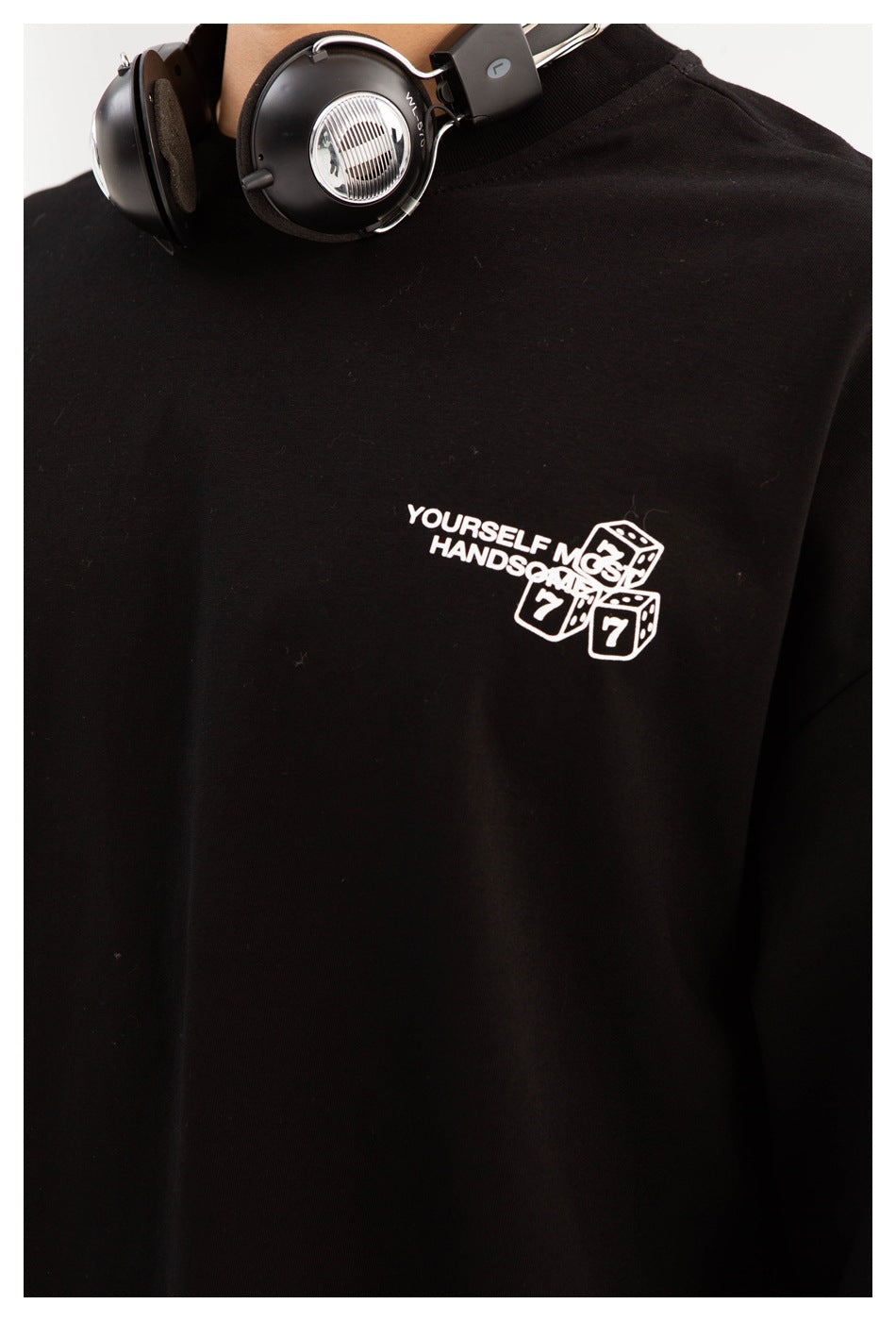 Close-up of the black shirt's chest, showing its small white text and dice graphic.