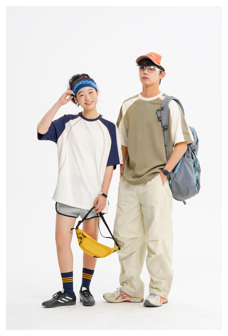 Two models pose in contrasting raglan shirts, one ivory and navy, the other olive and ivory.