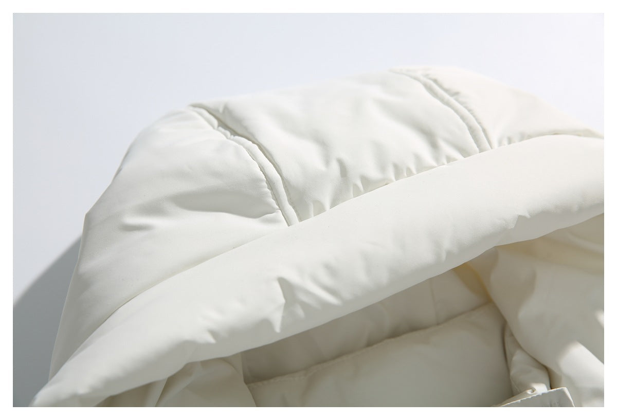 Close-up of the ivory jacket's quilted hood and padded edge.