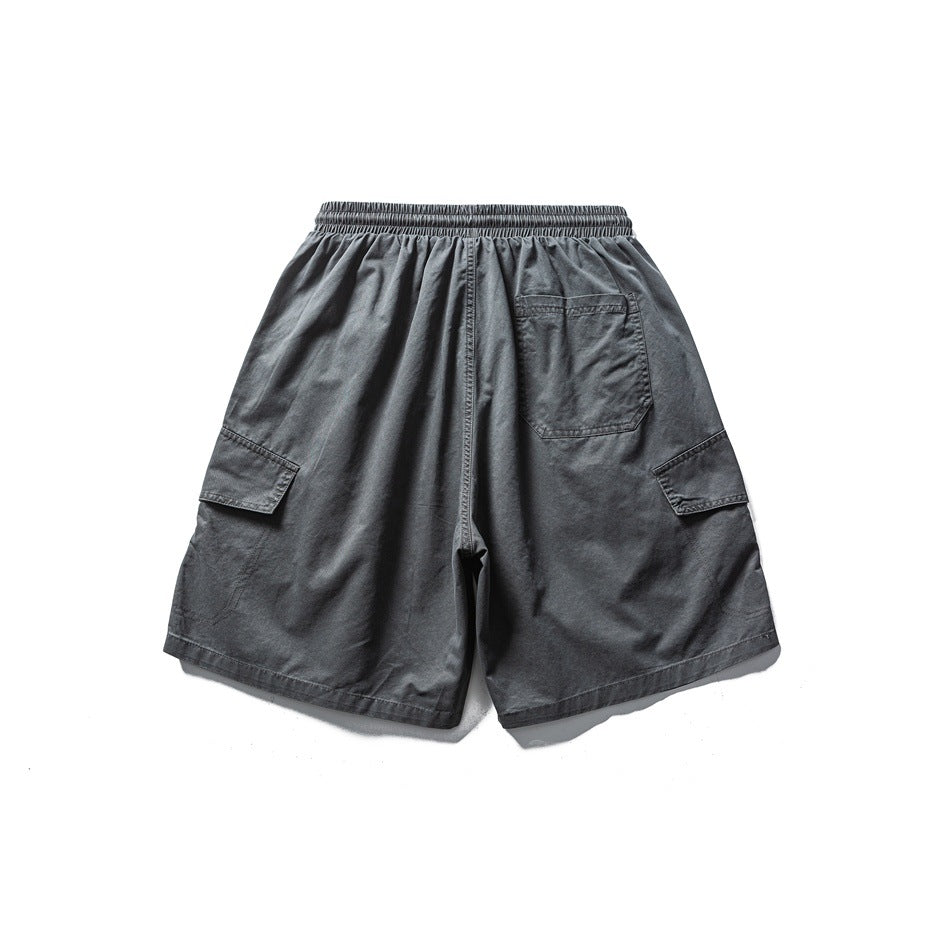 Dark gray cargo shorts flat lay, back view, with elastic waistband, back patch pocket and side flap pockets