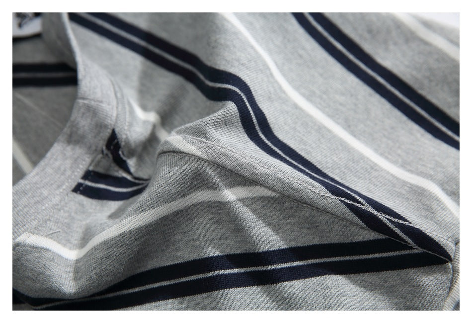 Close-up of the gray striped T-shirt's fabric and interior seam stitching.