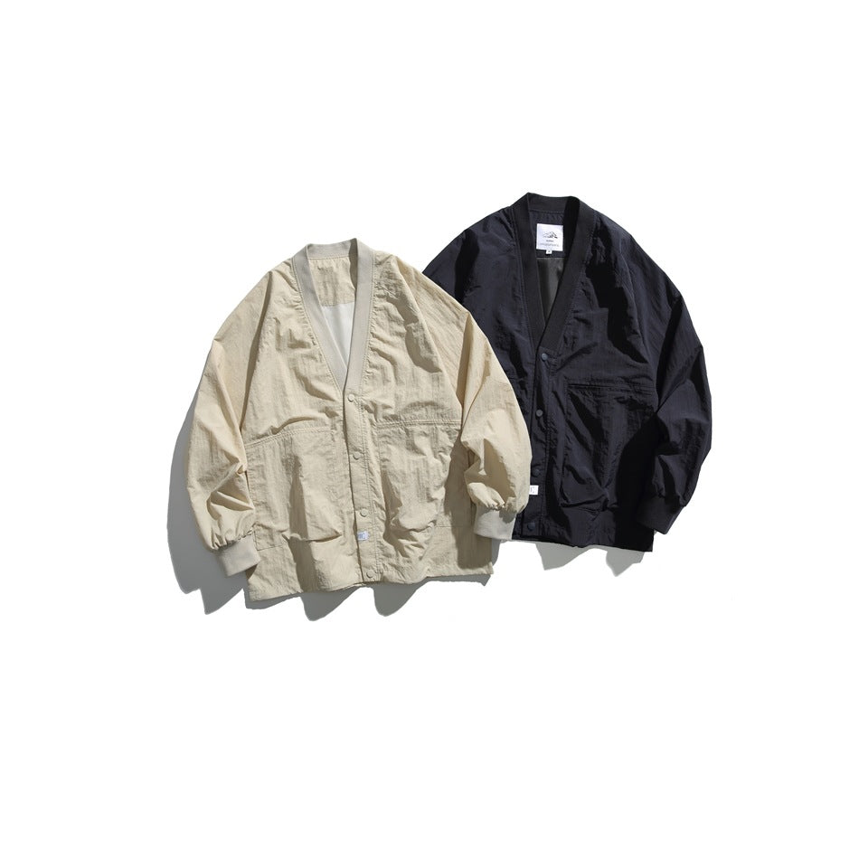 Two snap-front cardigan jackets displayed together: one light beige and one black.