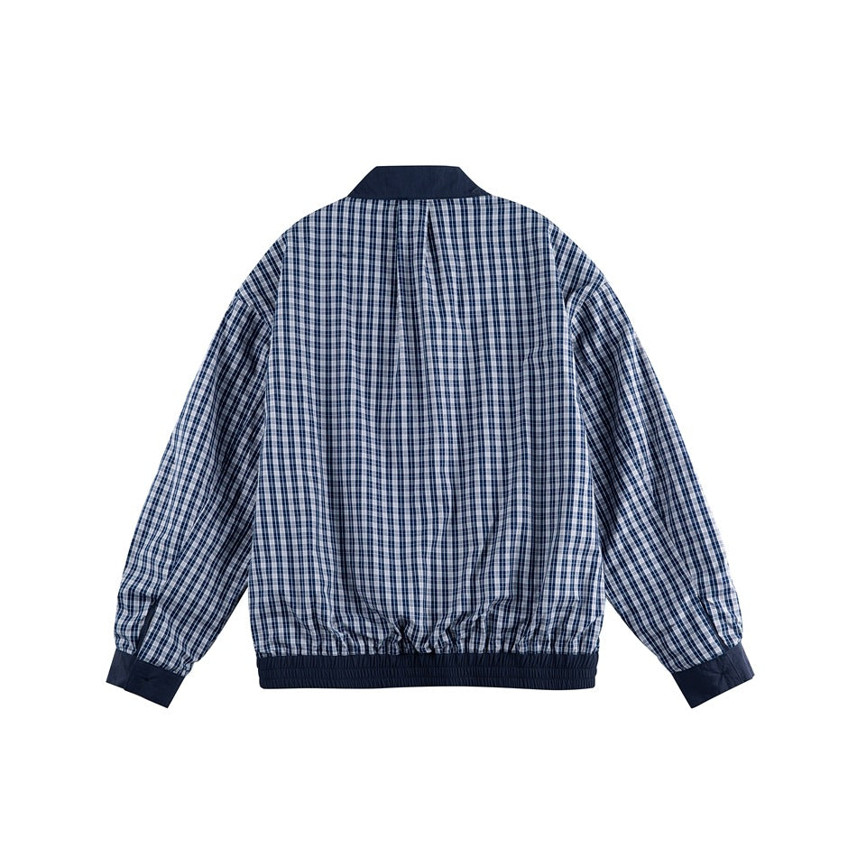 Back view of navy and white plaid jacket with navy collar, cuffs and elastic hem band, flat lay