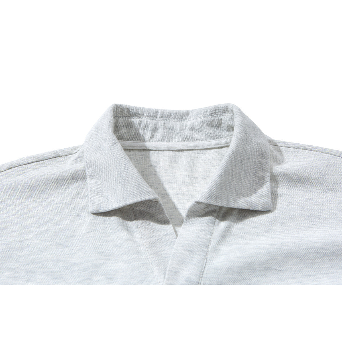 Close-up of a light gray polo shirt collar and open placket.