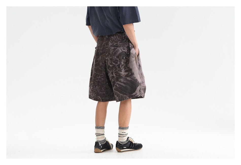 Back view of a model wearing dark gray abstract-print shorts with an elastic waistband and side pockets.