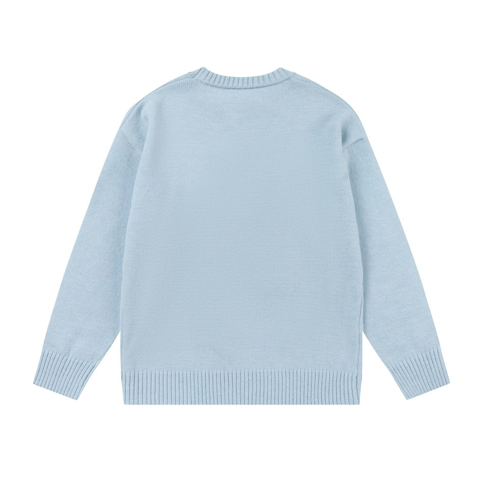 Back view of a light blue crewneck sweater with long sleeves and ribbed cuffs and hem, shown flat on white.