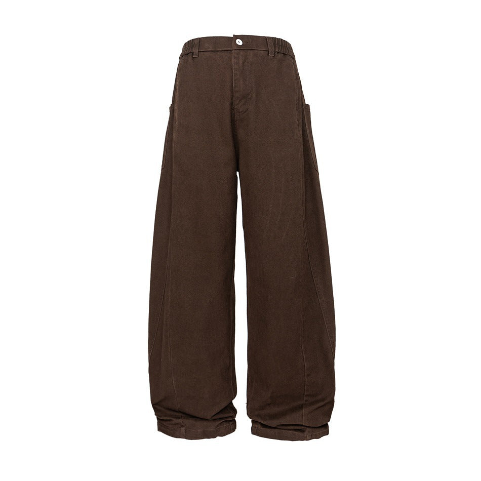 Brown wide-leg pants with elastic waistband, button fly, side patch pockets and curved seams, front view