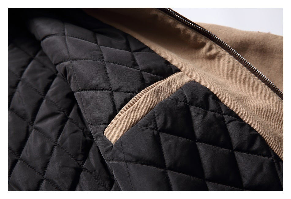 Close-up of the open tan jacket showing black diamond-quilted lining and the zipper.