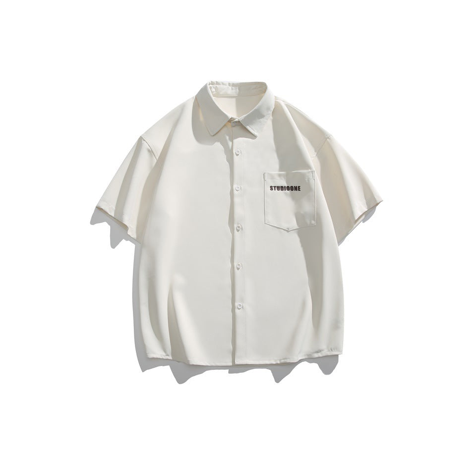 Ivory short-sleeve button-up shirt laid flat, with a pointed collar, chest pocket, and small dark lettering.