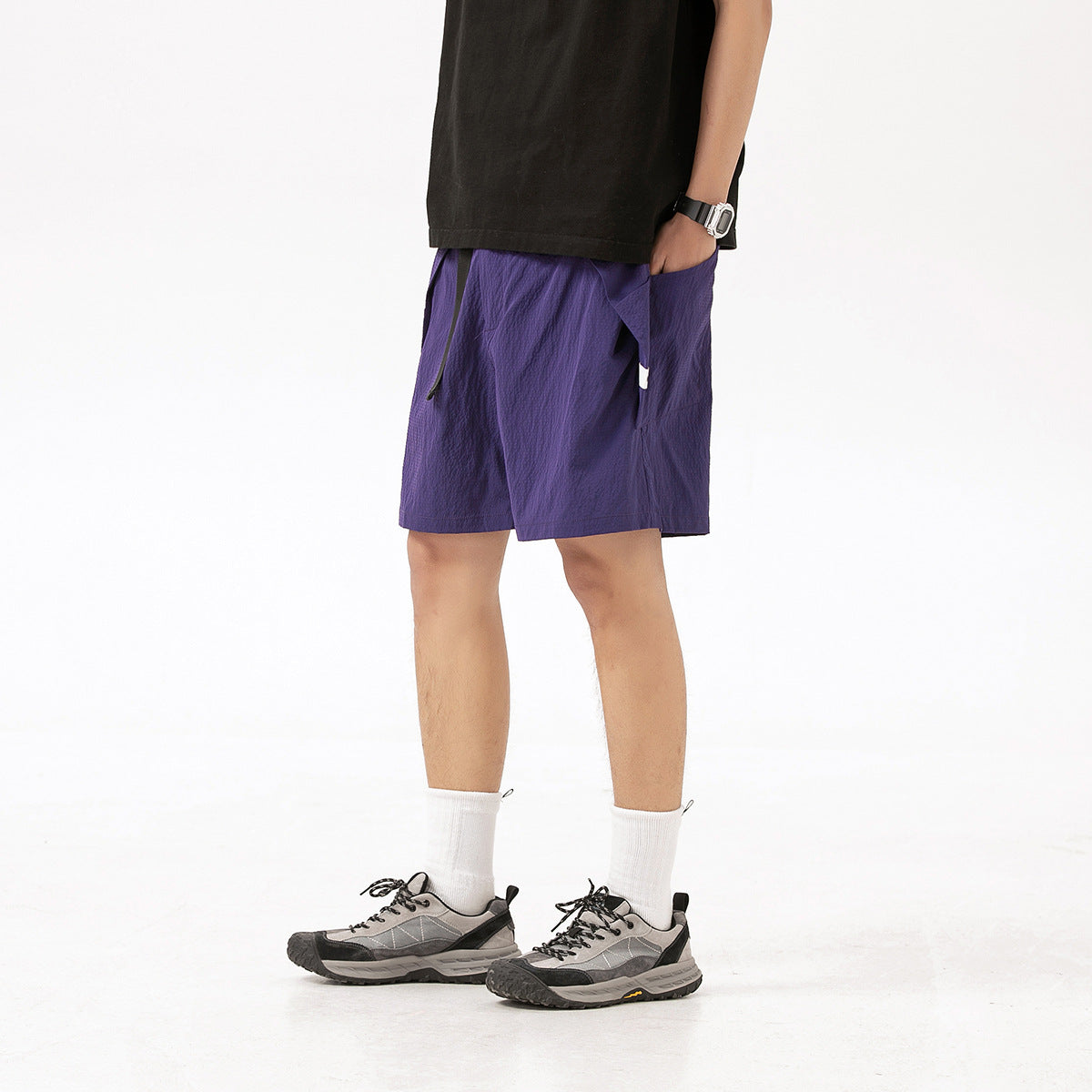 Model wearing purple knee-length shorts with a drawstring waist and side pockets.