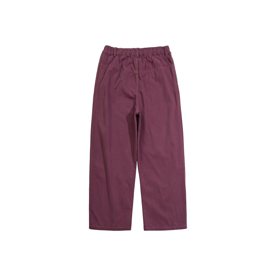Front view of plum wide-leg pants with an elastic waist, belt loops, and angled pockets on a white background.