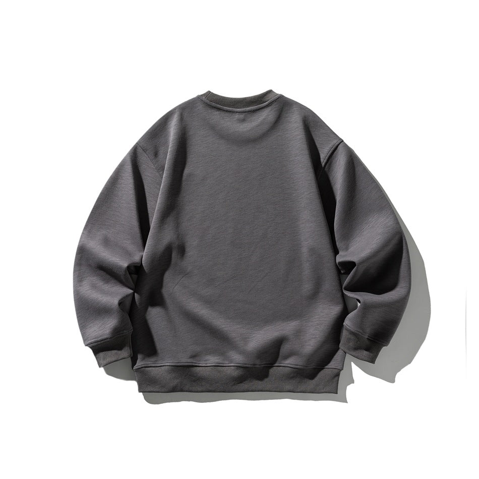 Back view of a charcoal gray crewneck sweatshirt with a relaxed fit and ribbed cuffs and hem.