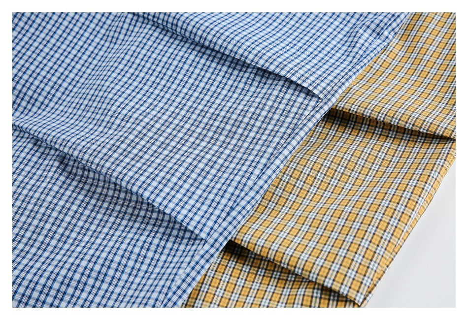 Blue-and-white and yellow checked pants arranged together, showing close-up views of the fabric and hems.