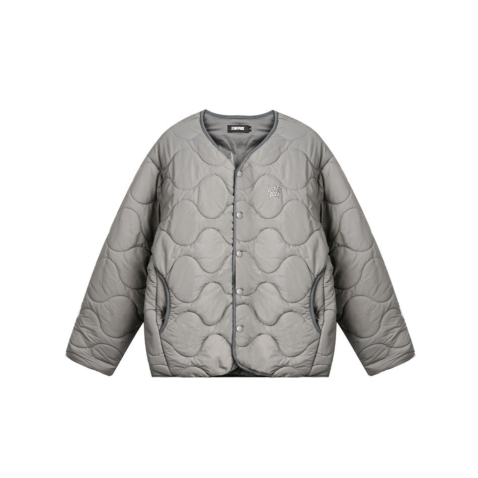 Front view of a light gray quilted jacket with a V-neck, snap buttons, curved pockets, and small chest lettering.