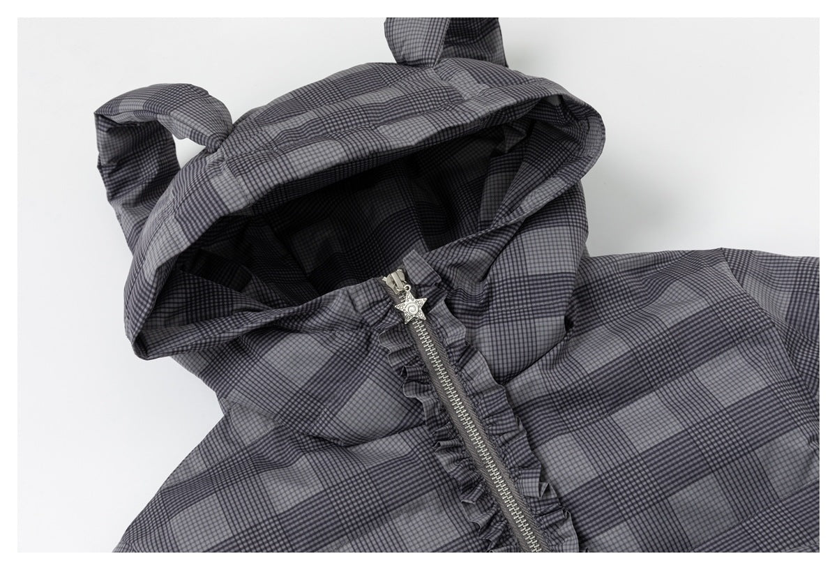 Close-up of a gray-and-black plaid hooded jacket showing its hood, ruffled front zipper and decorative star pull.