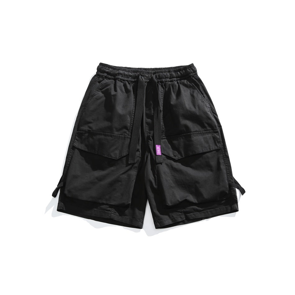 Black cargo shorts with large front flap pockets, elastic waist and drawstring strap with purple label