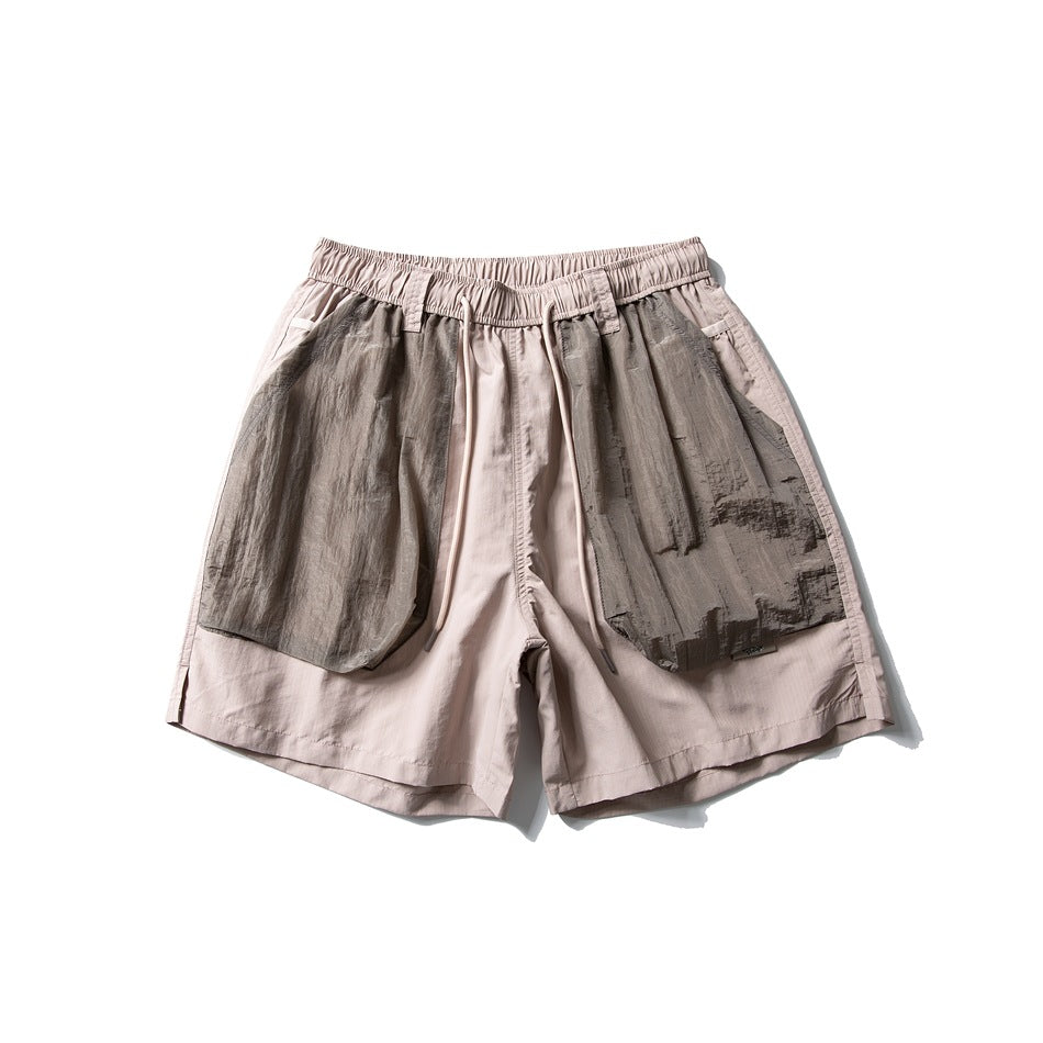 Dusty pink drawstring shorts with large taupe-gray crinkled patch pockets, flat lay front view