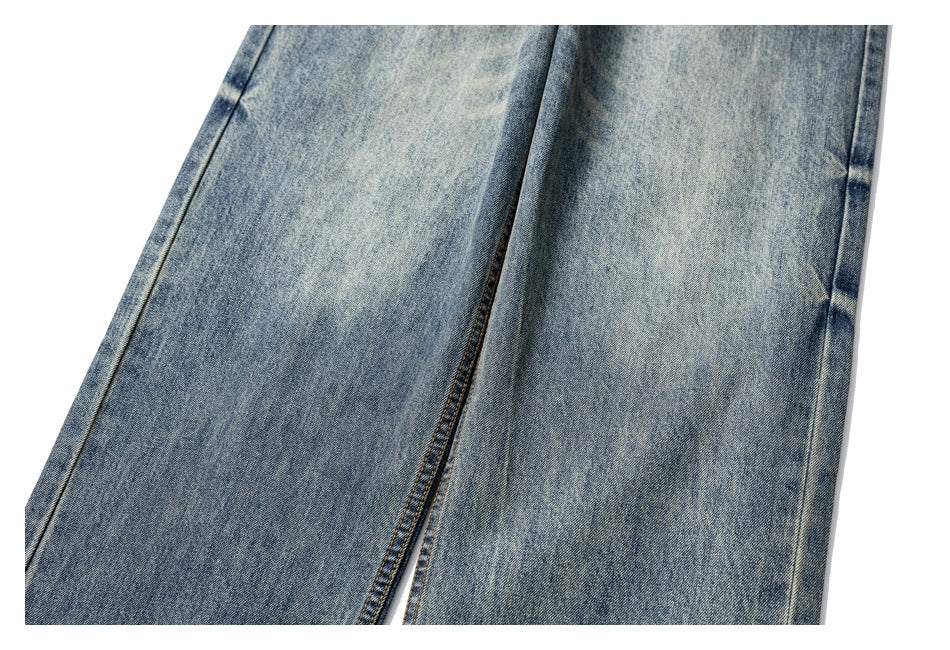 Close-up of the legs and seams of blue faded jeans.