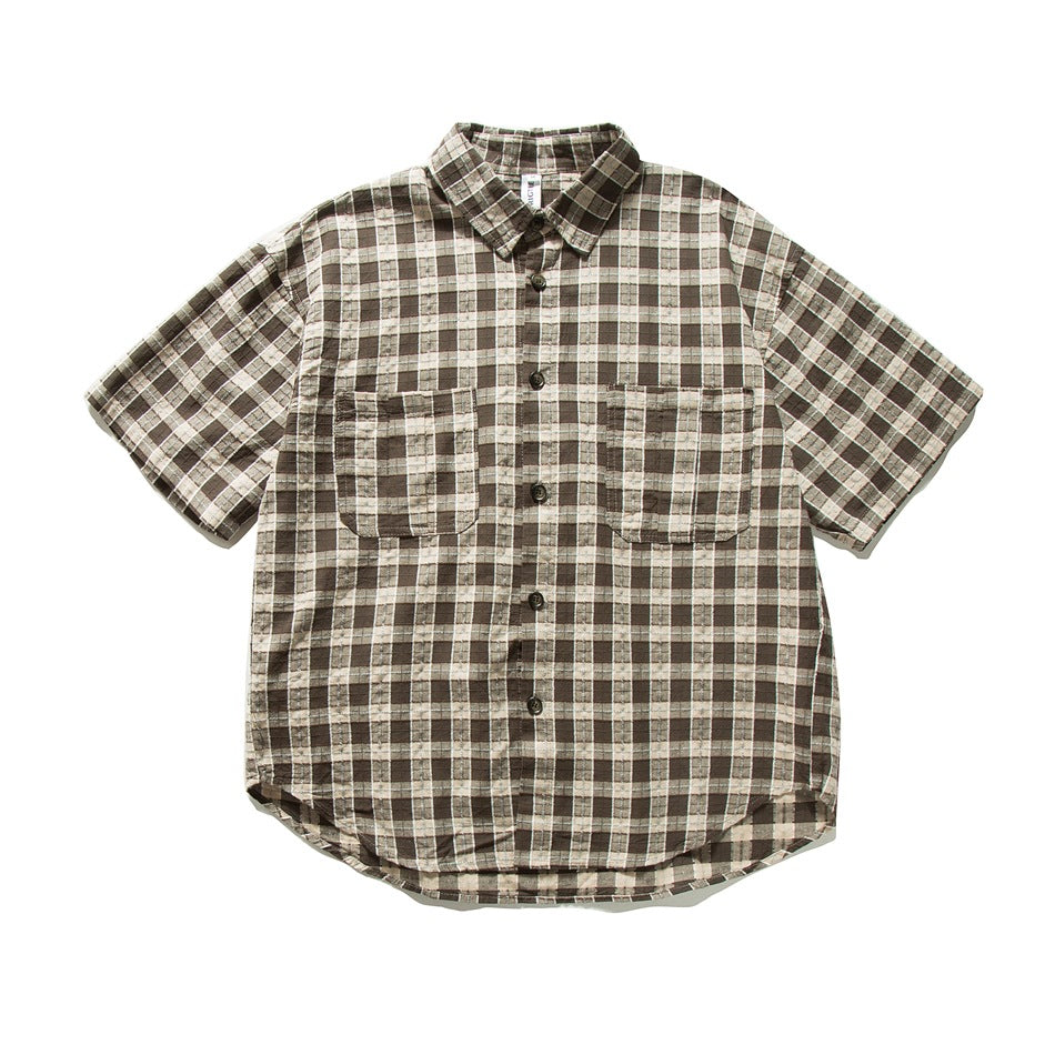 Brown and cream plaid short-sleeve button-up shirt with two chest pockets, flat lay front view