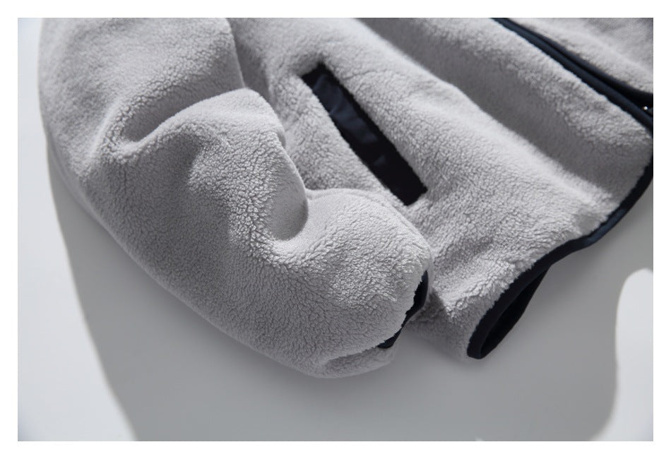 Close-up of the gray sherpa jacket sleeve cuff and adjacent slanted pocket with dark edging.