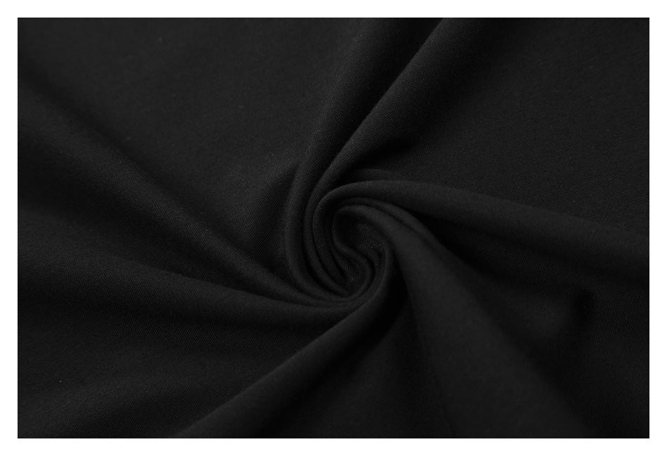 Close-up of black fabric gathered into a soft spiral fold.