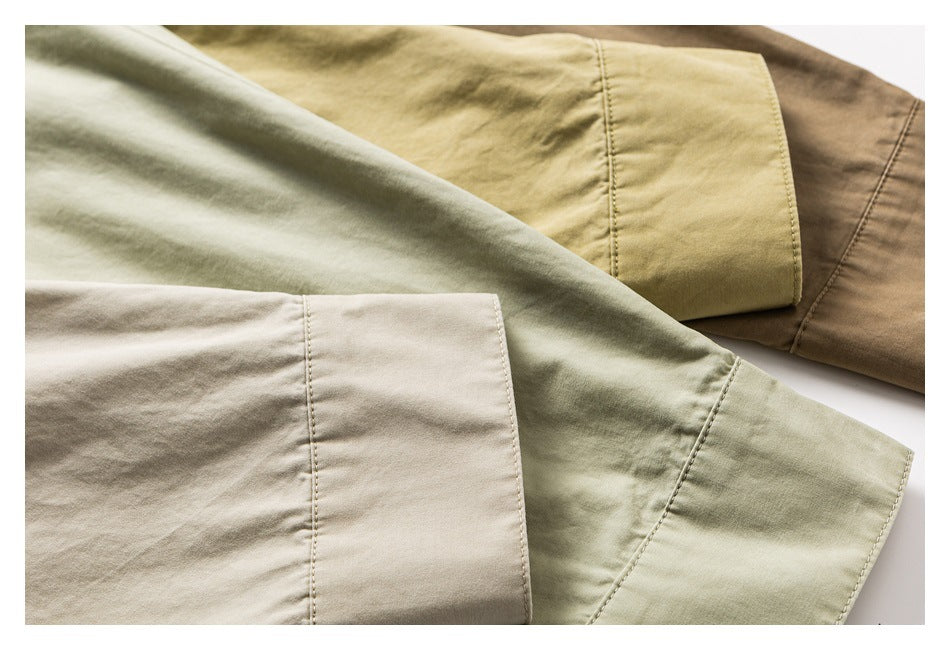 Close-up of overlapping shirt sleeves and cuffs in light beige, sage green, olive, and brown shades.
