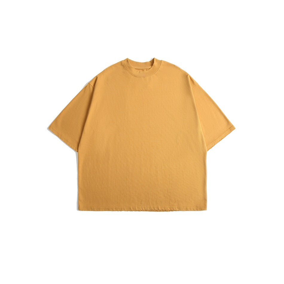 Front view of a plain oversized golden mustard T-shirt with a crew neck and short sleeves.