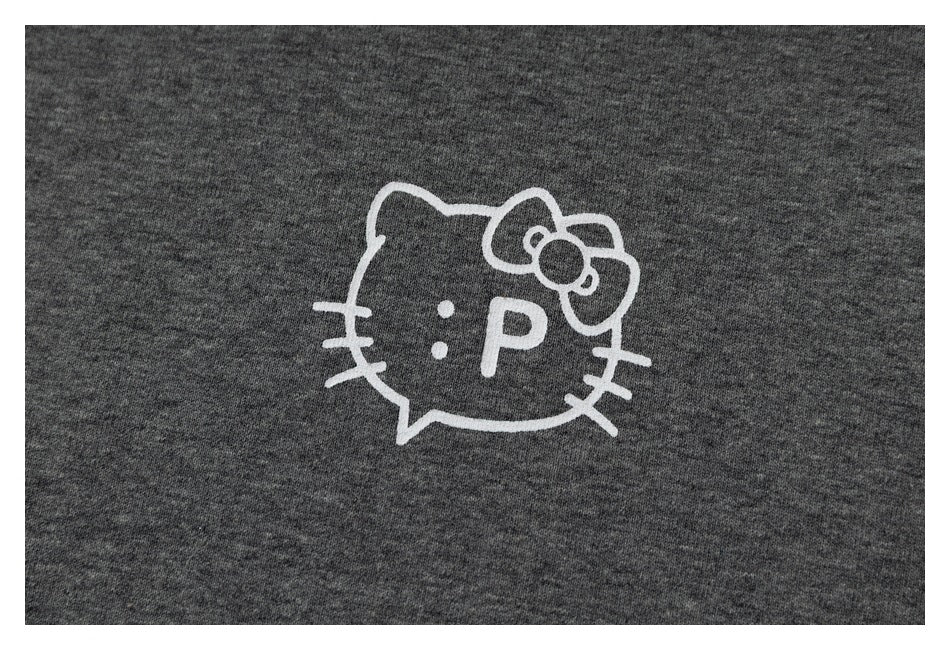 Close-up of a white outlined cat face with a bow and ":P" graphic on heather-gray T-shirt fabric.