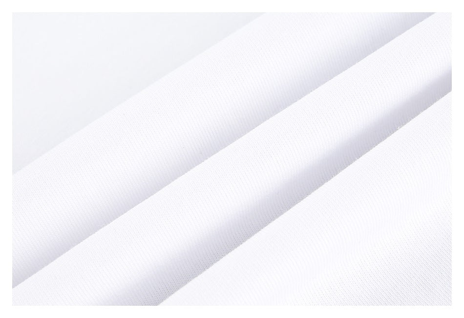 Close-up of white garment fabric arranged in soft diagonal folds, showing its surface texture.