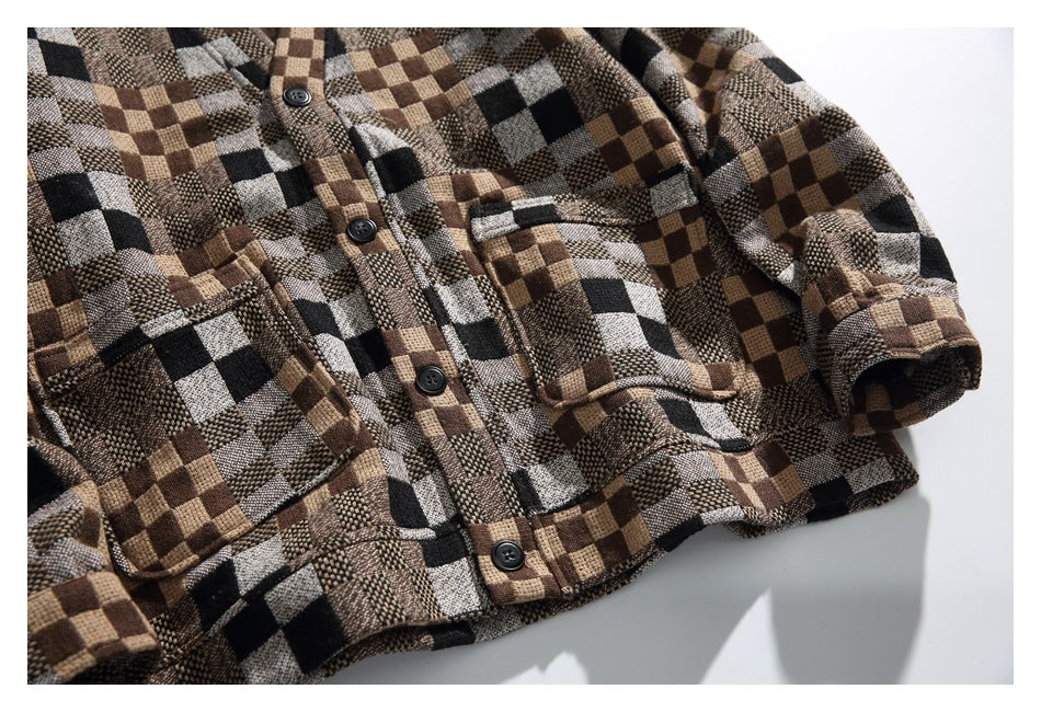 Flat lay showing the checkered shirt's button placket, two chest pockets, long sleeves, and cuffs.