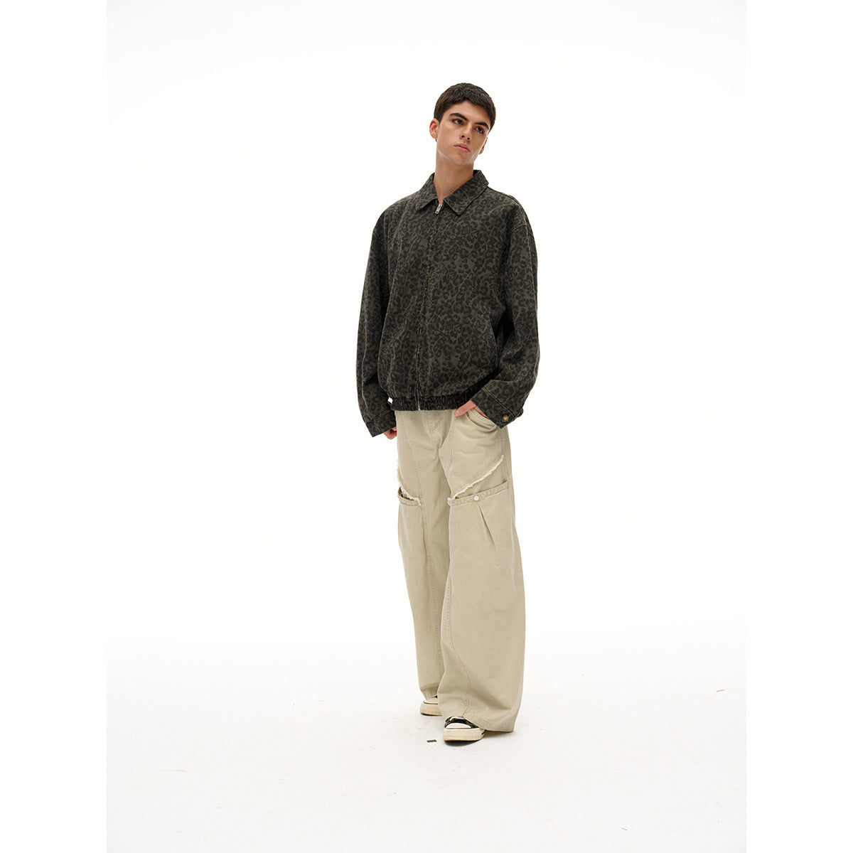Model wearing a dark leopard-print zip jacket and loose cream cargo pants, shown at a slight angle.