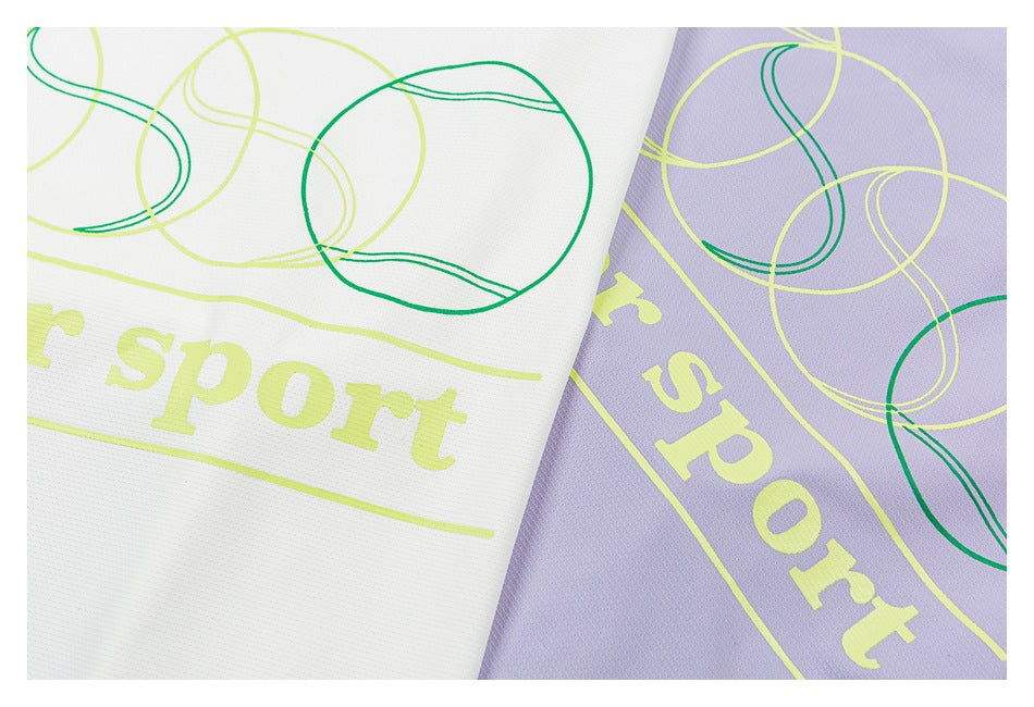 Close-up of white and lavender shirt fabric with lime lettering and green abstract loop graphics.