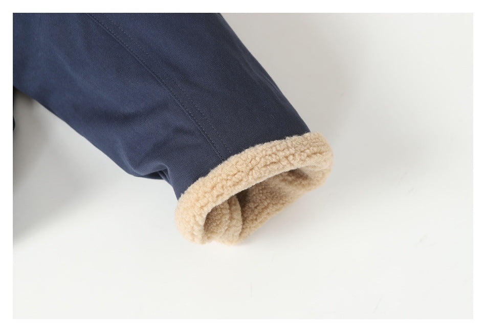 Close-up of a navy sleeve cuff lined with thick beige fleece.