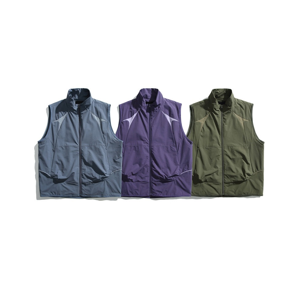 Three sleeveless zip vests shown from the front in slate blue, purple, and olive green.