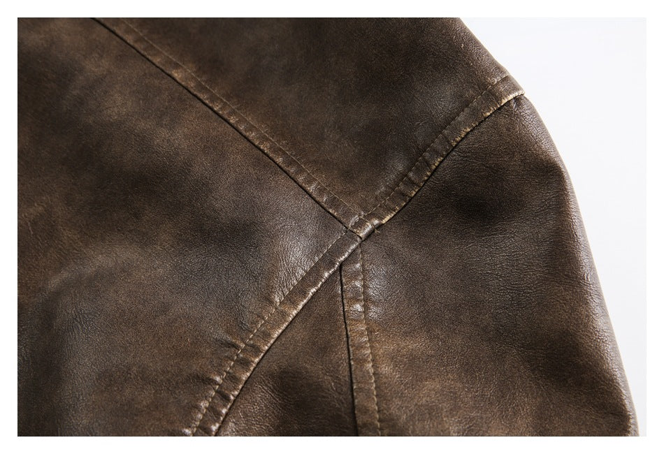Close-up of intersecting stitched panel seams on a dark brown jacket sleeve.
