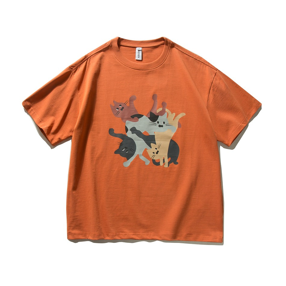 Orange short-sleeve crew-neck t-shirt with a front print of stacked cartoon cats, flat lay