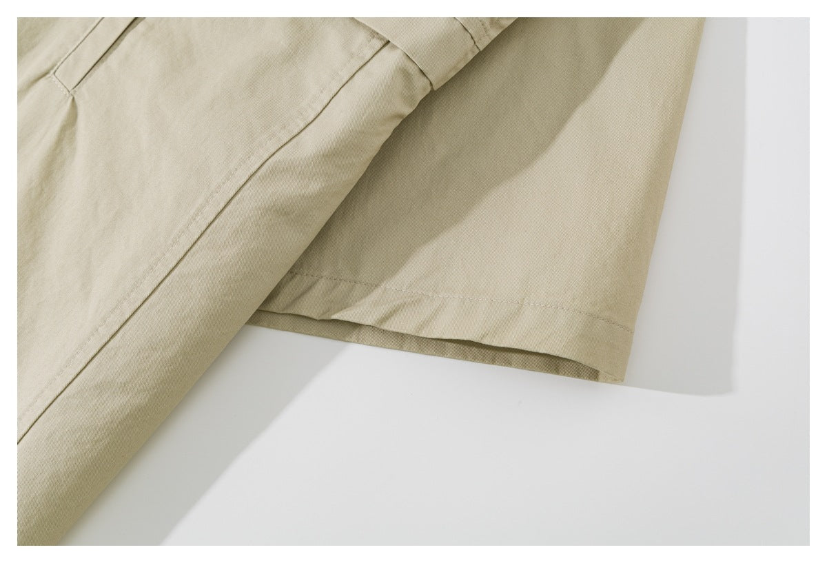 Close-up of a beige shirt sleeve and stitched hem.