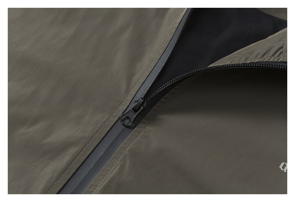 Close-up of an olive garment showing a black zipper and a small cropped white mark.